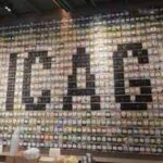 A wall mosaic made of coffee tile plaques spelling out CHICAGO at a coffee roastery