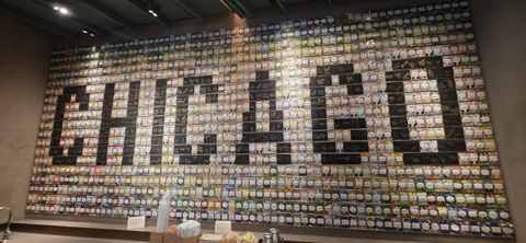 A wall mosaic made of coffee tile plaques spelling out CHICAGO at a coffee roastery