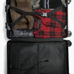 Open suitcase packed with clothes ready for travel
