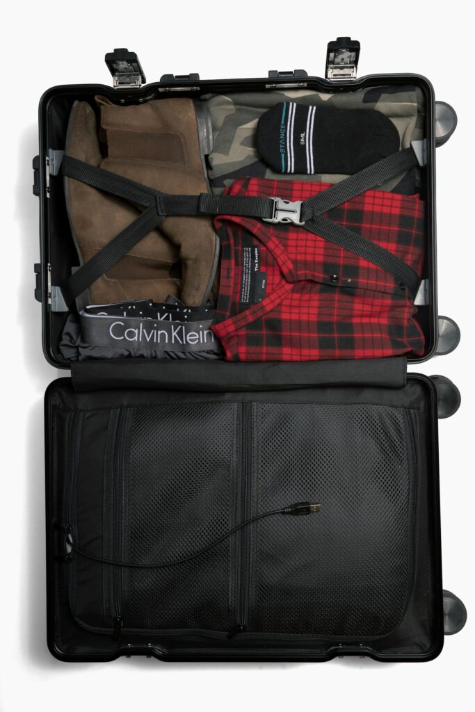 Open suitcase packed with clothes ready for travel