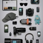 Flat lay of tech gadgets and electronics on a grey background