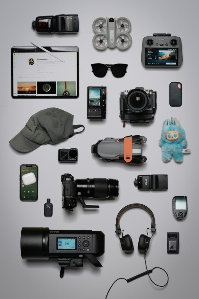 Flat lay of tech gadgets and electronics on a grey background