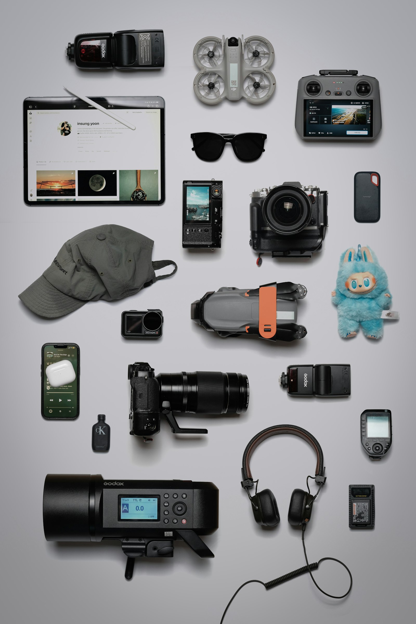 Flat lay of tech gadgets and electronics on a grey background
