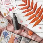 Flat lay of beauty and cosmetic products with magazines