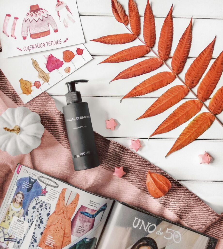 Flat lay of beauty and cosmetic products with magazines