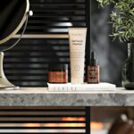 Minimalist skincare products arranged on a marble bathroom counter
